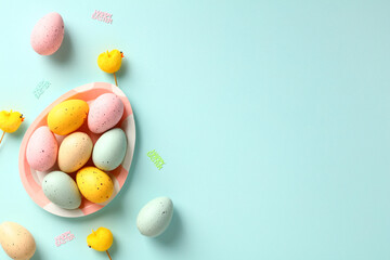Fototapeta na wymiar Happy Easter banner template. Creative layout with colorful Easter eggs on blue background. Flat lay, top view.