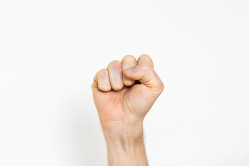 male fist on a white background. aggression, courage, masculinity concept