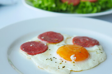 fried egg mixed with sausage on a plate 