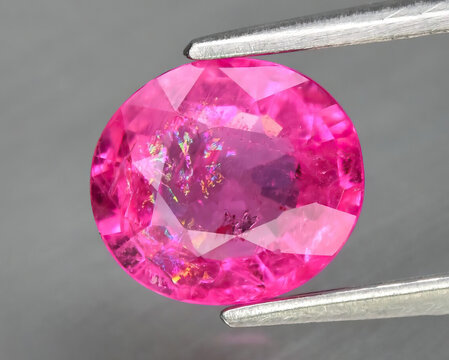 Natural gemstone red ruby on gray background