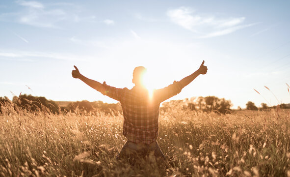 happy person young man with arms outstretched having a positive mindset 