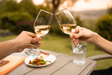 Couple enjoying a glass of wine and sunset nature view 