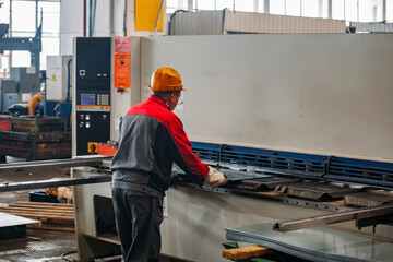 Operator working with CNC hydraulic press brake