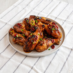 Homemade Easy Sticky Chicken Drumsticks on a Plate, low angle view.