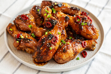 Homemade Easy Sticky Chicken Drumsticks on a Plate, low angle view. Close-up.