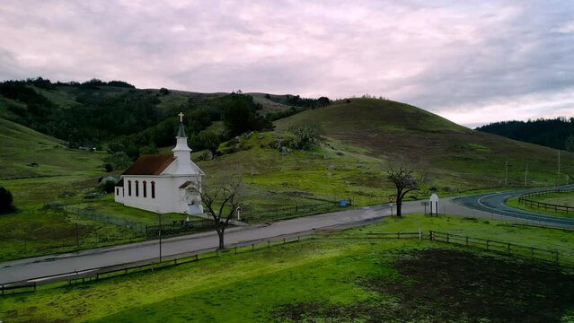 Small Church On Empty Country Road In Rural America With Sunrise Color In Sky