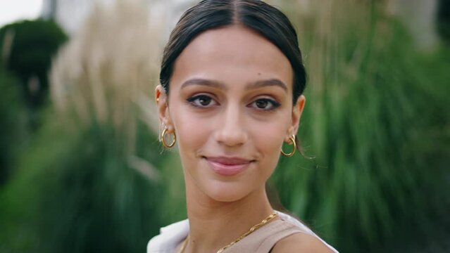 Closeup smiling girl looking camera outdoors. Portrait happy woman posing nature