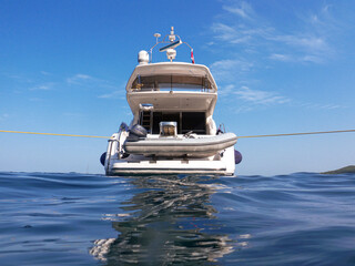 Summertime luxury motor yacht anchored off the coast of the Zorakas Bay, Greece.