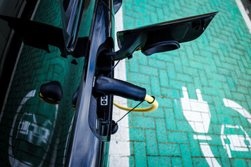 Plug in charging electric vehicle on parking