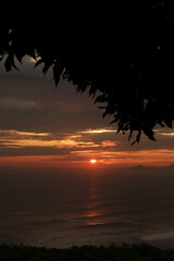 Photo of a dramatic sunset over the ocean with storm clouds in the sky (Lima, Perú)