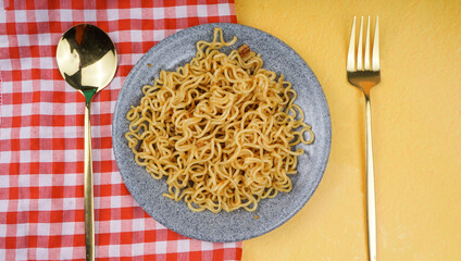 Mie goreng. Instant noodles. Fried noodles. Fried noodles are placed on a plate. Fried noodles from Indonesia. Top View