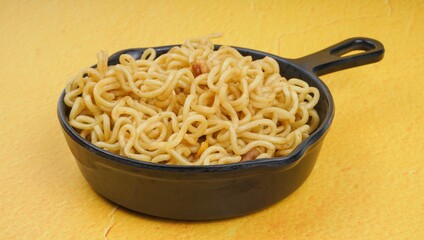 Mie goreng. Instant noodles. Fried noodles. Fried noodles are placed on a plate. Fried noodles from Indonesia. Closeup photo.