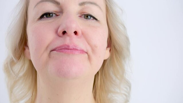 Portrait of Caucasian woman shoving tongue gymnastic exercise. Training of diction. Isolated on white background. High quality 4k footage