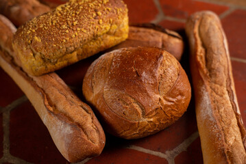 different types of French bread. Baguettes, bread with seeds on the kitchen table.