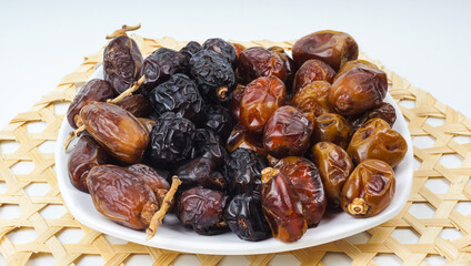 Fresh various dates fruits (kurma) over white background