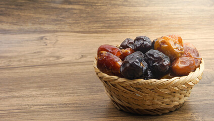 Various of dried dates or kurma over wooden background