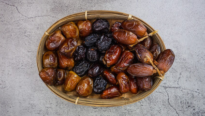 Set of various dates in bamboo basket. selective focus