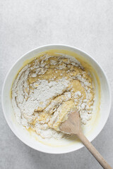 Vanilla muffin batter in a mixing bowl, process of making cupcakes and muffins, folded batter