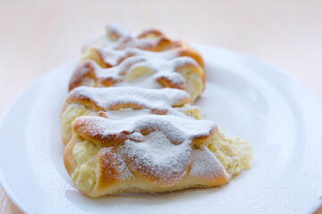 homemade cakes pies with cottage cheese sprinkled with powdered sugar on white round plate Bright table grandmother's pies for children grandchildren are made with love