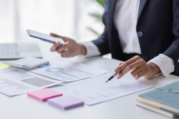 Businessman accounting working at office with calculator documents on his desk, doing planning analyzing the financial report, business plan investment, accounting finance analysis concept