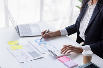 Businessman accounting working at office with calculator documents on his desk, doing planning analyzing the financial report, business plan investment, accounting finance analysis concept