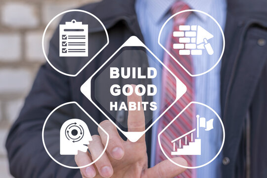 Build good habits concept. Businessman using virtual touchscreen presses inscription: 'BUILD GOOD HABITS'. Business, psychological and build good habits.