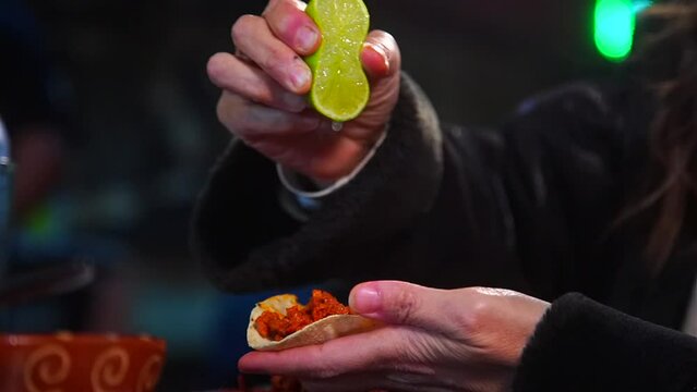 Adding Lemon Juice to an Authentic Mexican Pastor Taco.