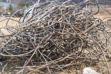 Twisted metal rods in abstract pile, on construction site