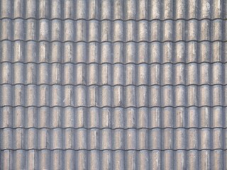 The texture of old grey roof tiles on a roof house for background and wallpapers