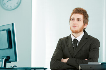 Young clerk daydreams in office.