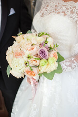 bride holding wedding bouquet with her hands	