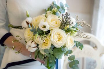 bride holding wedding bouquet with her hands	