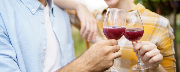 Happy cheerful smiling of grape farmers showing a vine fruits and grape juice in a glass.