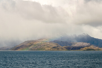 Mountain scene through a rainbow in the Straits of Magellan in southern Chile