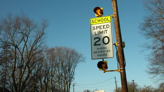 School zone 20 miles per hour traffic sign flashes activated warning lights