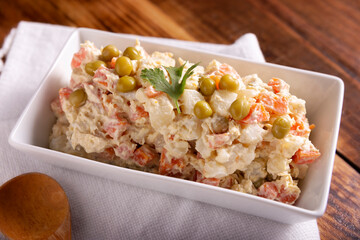 Russian Salad, also known as Oliver Salad. Very popular dish in several countries, the main ingredients are commonly potatoes, mayonnaise and vegetables such as peas, carrots, boiled eggs or chicken.