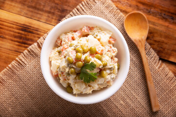 Russian Salad, also known as Oliver Salad. Very popular dish in several countries, the main ingredients are commonly potatoes, mayonnaise and vegetables such as peas, carrots, boiled eggs or chicken.