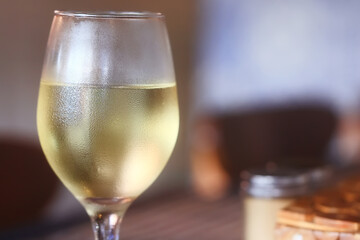 a glass of white wine in a restaurant, alcohol luxury background