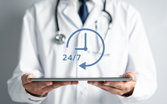 Doctor in a white coat uniform holding 24/7 service icon for assistance patient when accident or emergency, Medical call center service without interruption day and night. - Powered by Adobe