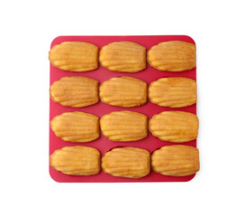 Tasty madeleine cookies in baking mold isolated on white, top view
