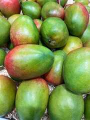A wide selection of delicious, ripe mangoes available at the farmer's market