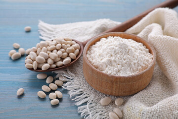 Fototapeta na wymiar Kidney bean flour and seeds on light blue wooden table, closeup