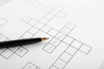 Crossword with answers and pen, closeup view