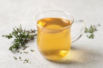 Aromatic herbal tea with thyme on light table