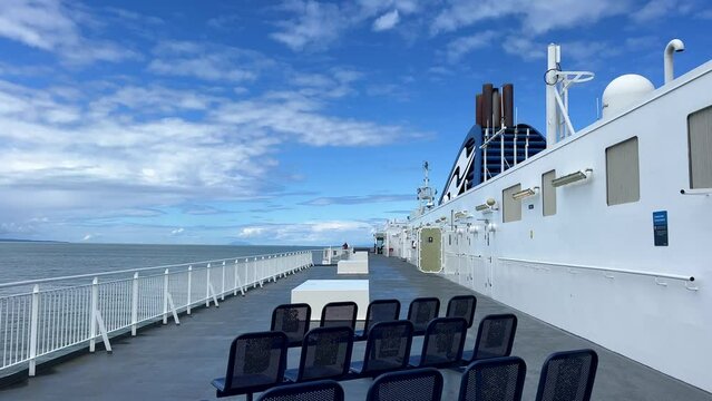 The upper deck of the ferry departing from Canada to Vancouver Island is a clean white deck with a blue flag white stripes on a blue background This is the flag of the ferry everywhere sea-ocean.