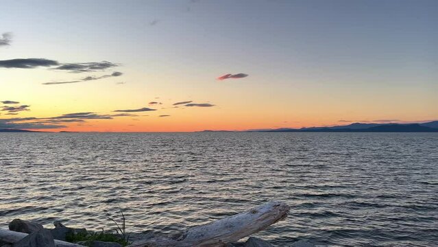 sunset on Ocean Horizon mountains are far visible many clouds and bright colors slow motion video suitable for music relaxation background For text silence peace Parksville beach Surfside RV resort