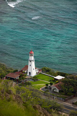 Fototapeta na wymiar Aerial lighthouse on the beach cliff shore with ocean 