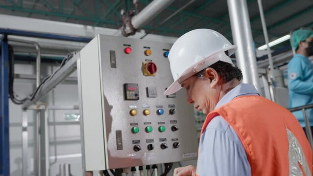 Mechanic or maintenance or electrical engineer checking main electrical control systems industrial plant. Utility fore man daily check power systems in process. Main Distribution Board, Switchboards