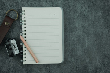 Open a notebook with blank space and pencil and roll film. The concept of nostalgia and memory