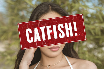A catfish alert sign or someone pretending to be an attractive person. A fake profile using a stolen photo. A false identity used to pursue deceptive online romance. Catfishing detection concept.